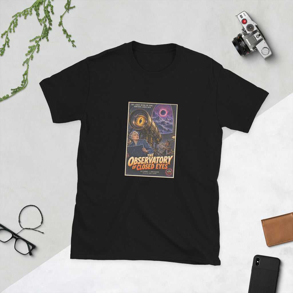 Black t-shirt printed with a vintage-style horror poster: a giant golden eye inside a brass telescope above an older woman astronomer and a young technician, an eclipse overhead, titled The Observatory of Closed Eyes