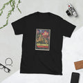 Black t-shirt printed with a vintage-style horror poster: a woman with a lantern among giant orchids with human faces inside a glass greenhouse, titled The Greenhouse of Borrowed Faces